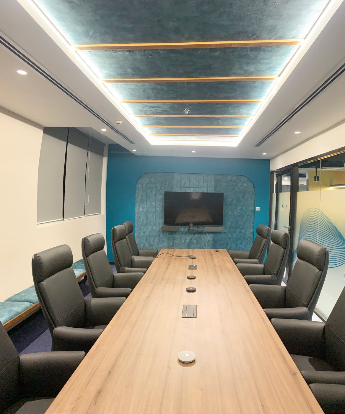 Boardroom with timber table and illuminated feature ceiling at the Axonect office, Colombo
